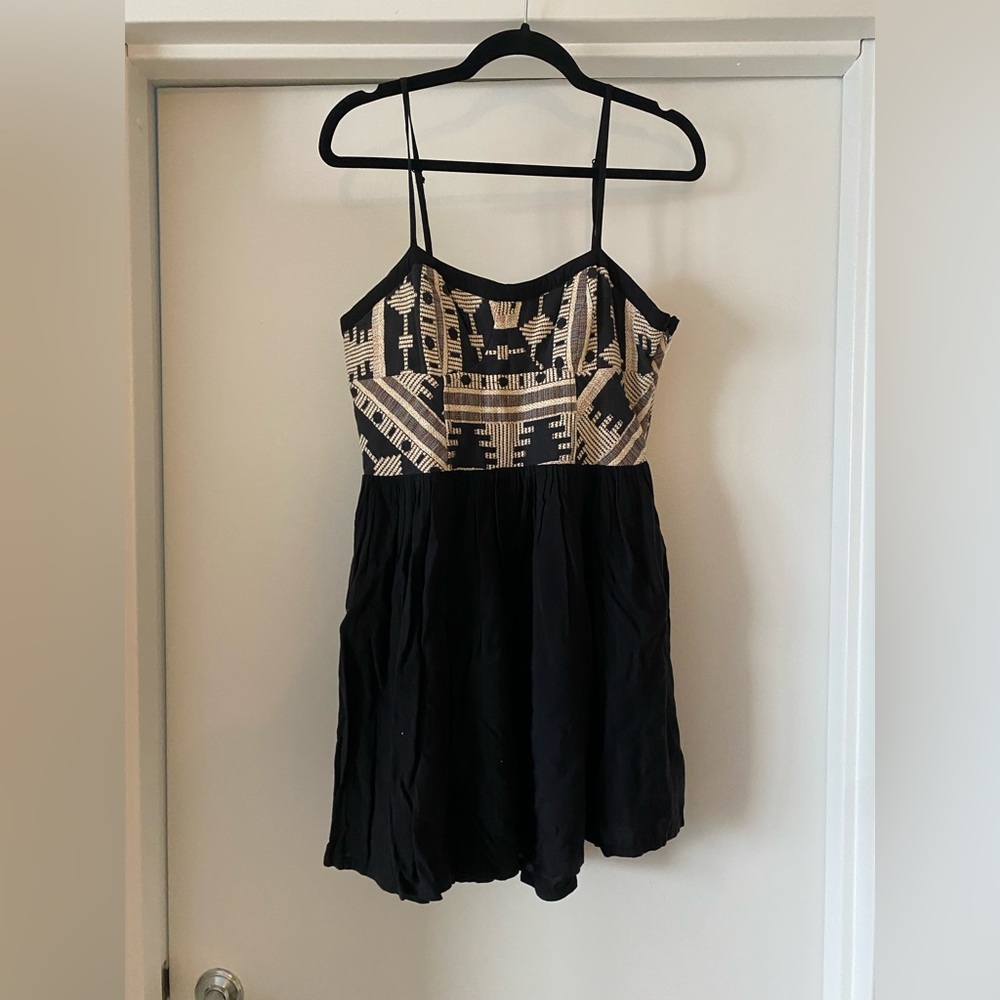 Black spaghetti strap dress with a geometric pattern top.